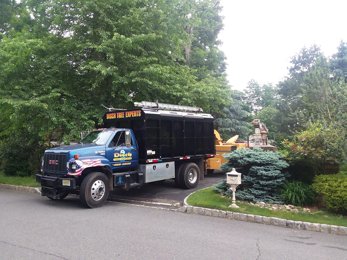 Disch GMC chip truck on a residential job